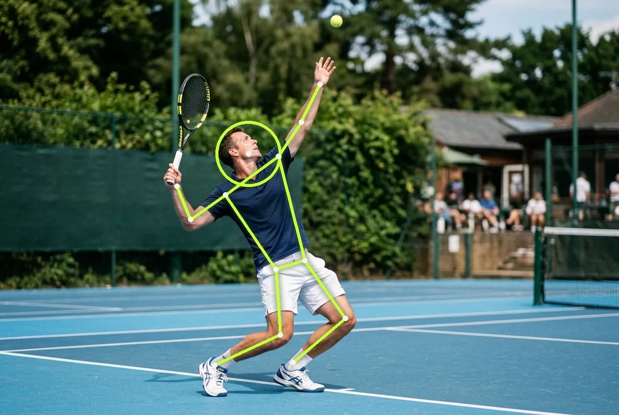 A club player at the trophy position of a serve on a sunlit hard court